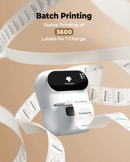 The Phomemo M110 Portable Label Printer, surrounded by printed labels, is labeled with Batch Printing and Stable Printing of 3600 Labels for 1 Charge. This sleek printer has a compact design with Bluetooth connectivity and a small display.